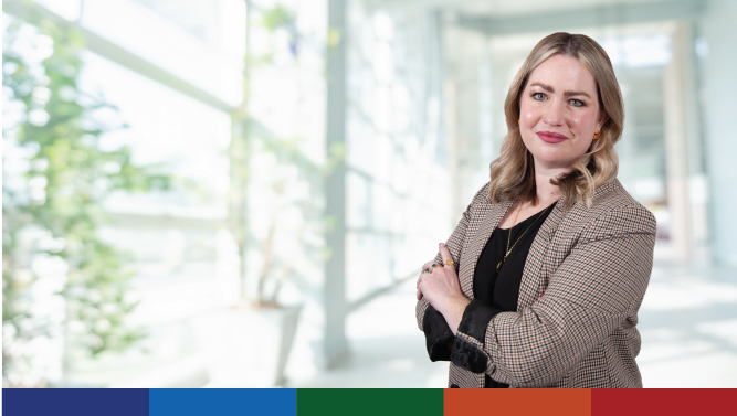 A Scottish Government staff member pictured in a bright office walkway.