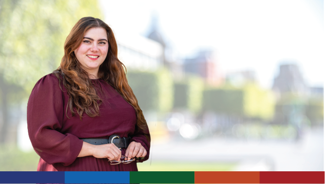 A photograph of a Scottish Government staff member pictured outside an office on a sunny day.